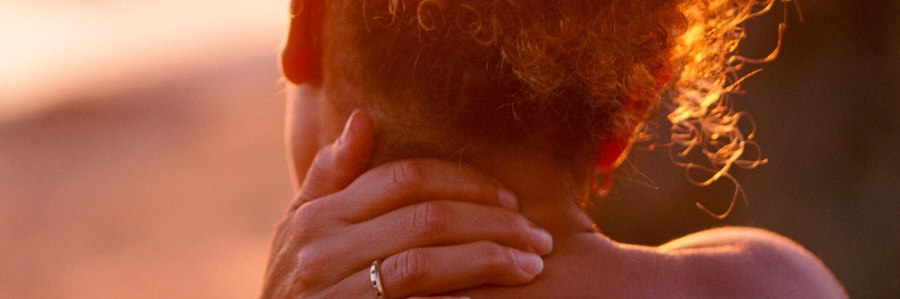 What to Know to Understand the Experience of Having Chronic Pain Rear view of woman with hand on neck