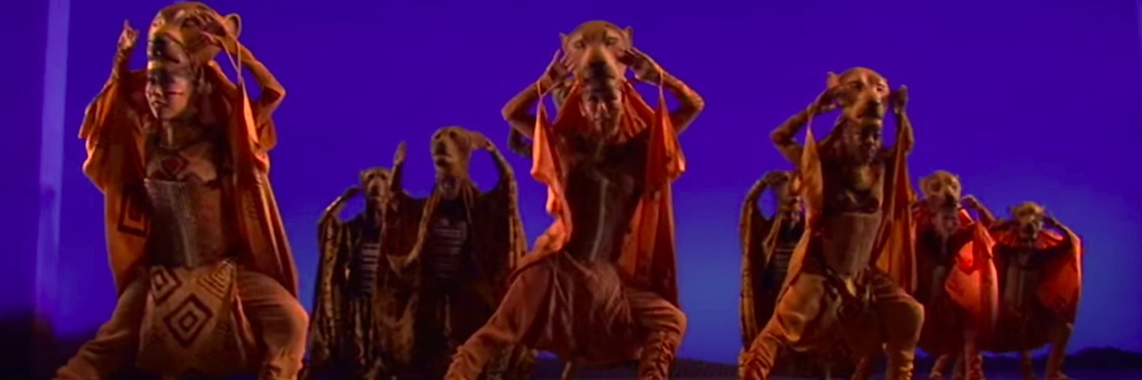 Going to an Autism-Friendly Performance of 'The Lion King' on Broadway Scene from The Lion King on Broadway - performers dancing dressed as lions