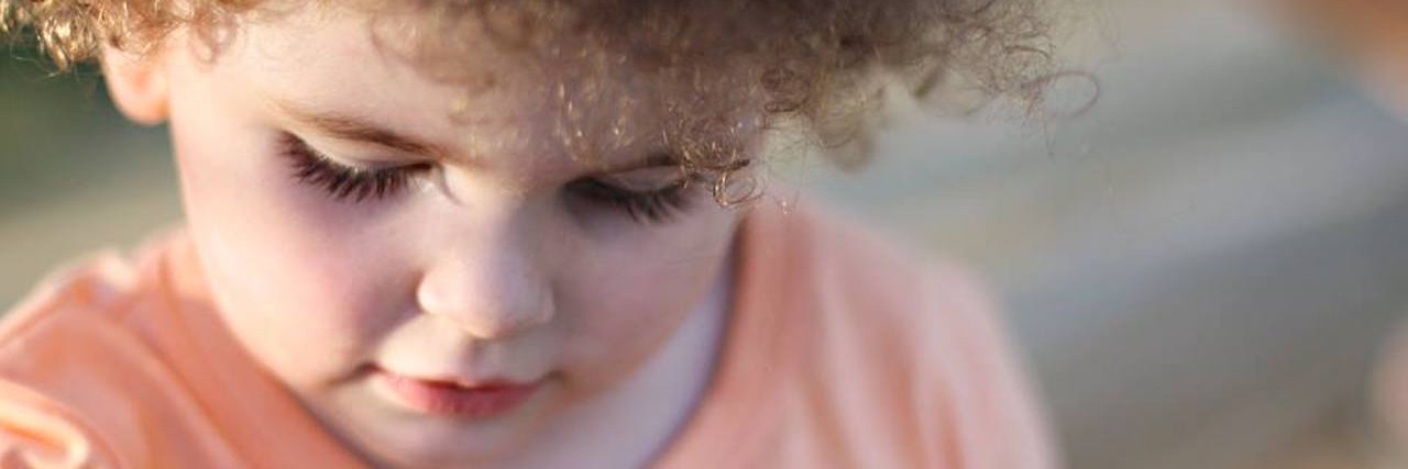 How to Help Your Kid Feel Comfortable Saying Hi in Public little boy with curly hair