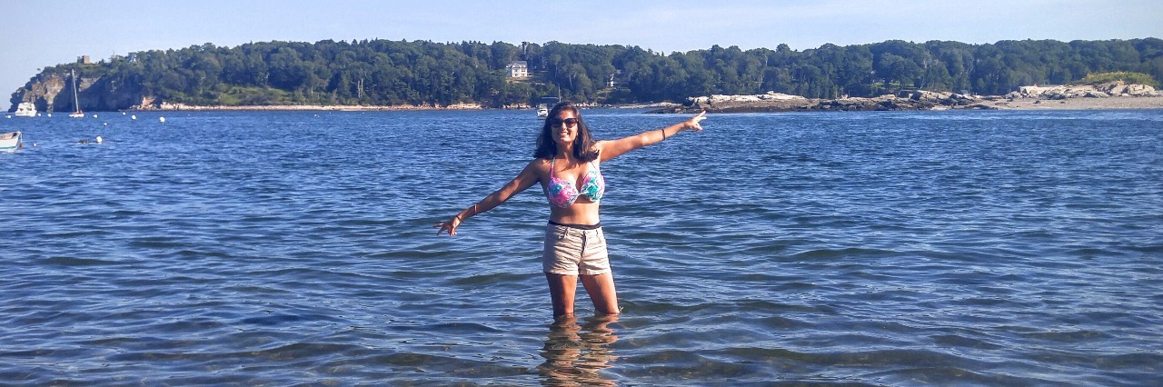 Alessia Cara 'Scars to Your Beautiful' Meaning to Woman With Crohn's girl standing in lake with arms out