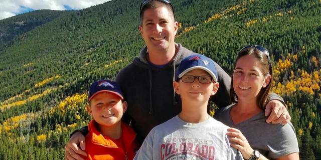 What People Don't See in My Son's Journey With Cyclic Vomiting Syndrome Denise and her family by the mountains