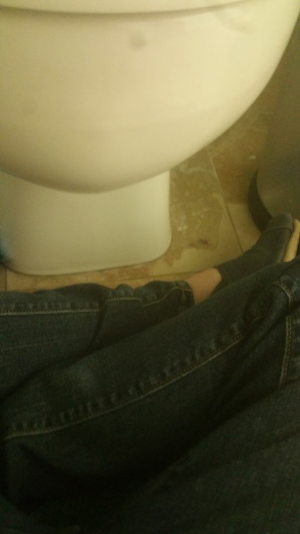 woman sitting with legs crossed in front of the toilet