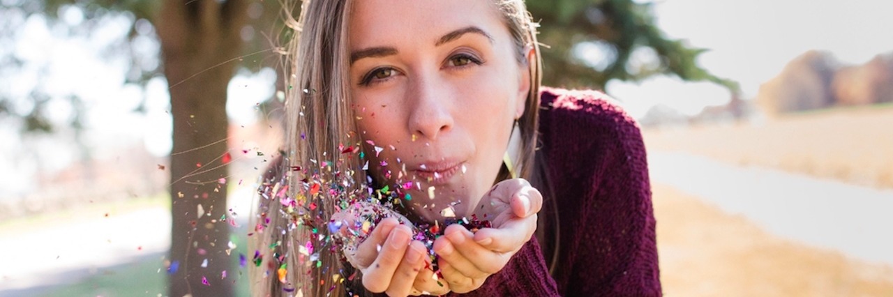 What You Should Know About Your Loved One With Anxiety A woman blowing glitter out of her hands