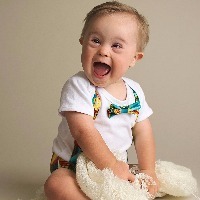 Young boy with down syndrome with a huge smile on his face