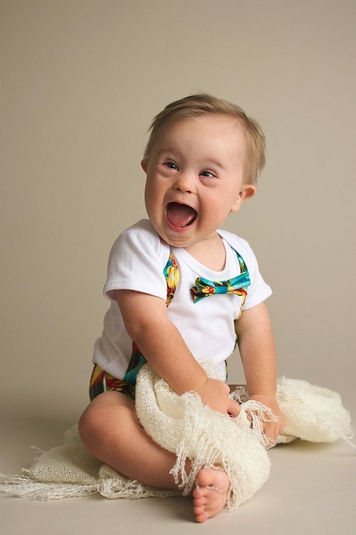 Young boy with down syndrome with a huge smile on his face