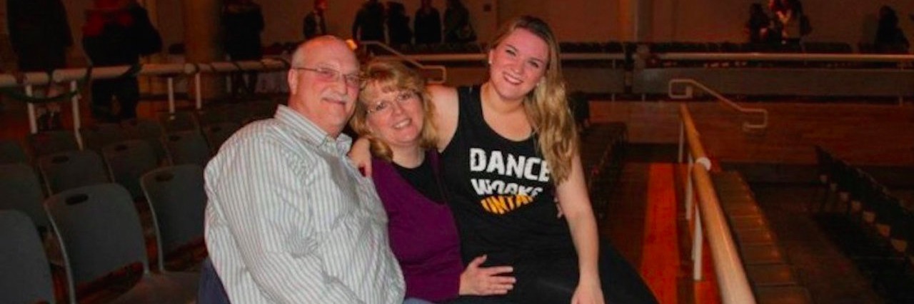 Woman With Gastroparesis Is Thankful for Her Parents’ Support parents sitting with their daughter in an auditorium