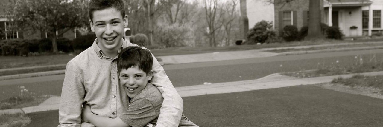 My Brother With Down Syndrome Inspires Me to Speak Out brothers hugging