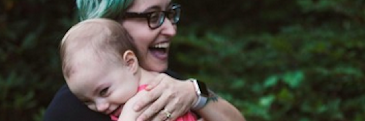 Why It Is OK to Take Medication for Postpartum Disorders A mom and her small daughter resting on her shoulder