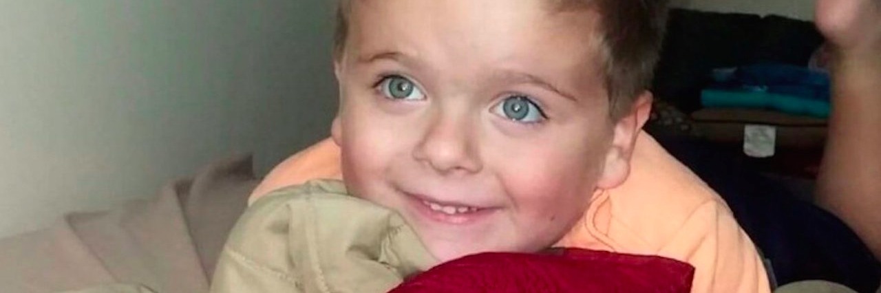 Connecting With My Son With Autism Through a Song young boy looking up while lying on bed