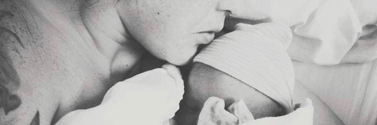 Letter to Parent Who Just Received a Prenatal Down Syndrome Diagnosis Black and white photo of mother holding newborn baby