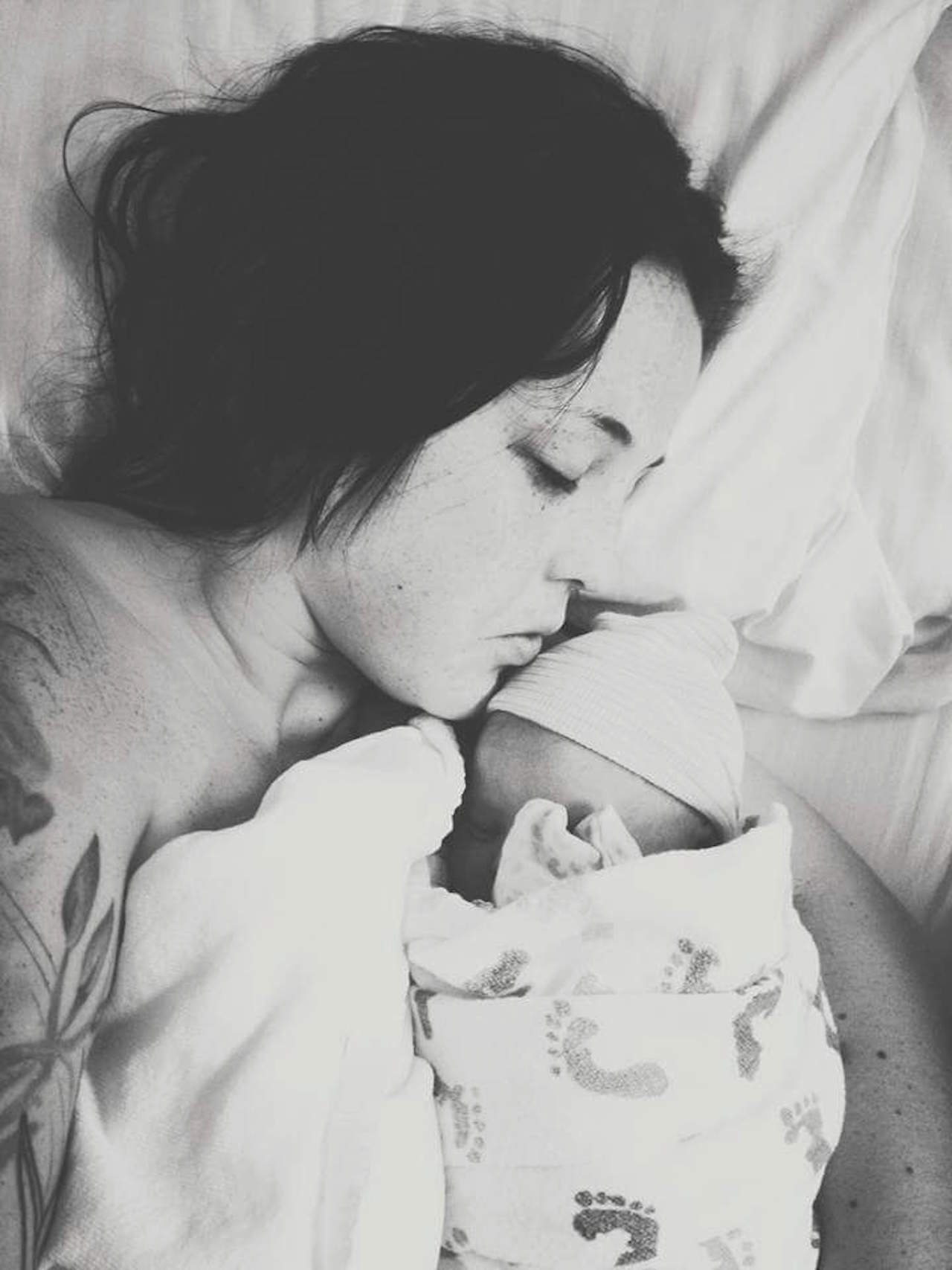 Black and white photo of mother holding newborn baby