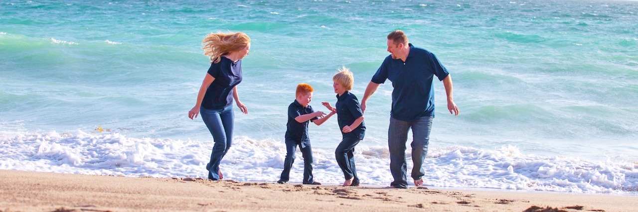 Ways to Help Grieving Families Through Painful Times Mother and father with two sons on the shore at the beach