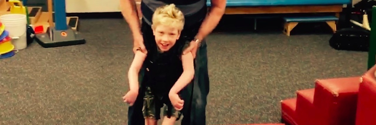 What It's Like to Have a Sibling With Aicardi-Goutieres Syndrome Gavin taking steps in physical therapy