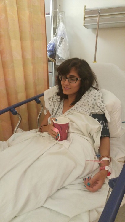 girl sitting in hospital bed