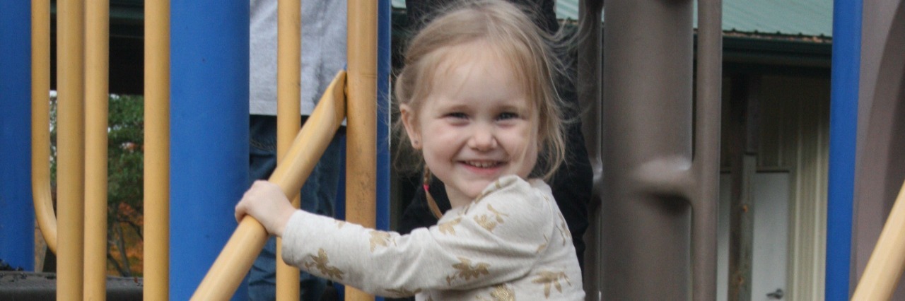 Gifts I Didn't Expect After My Daughter's Autism Diagnosis little girl playing on play structure at the park