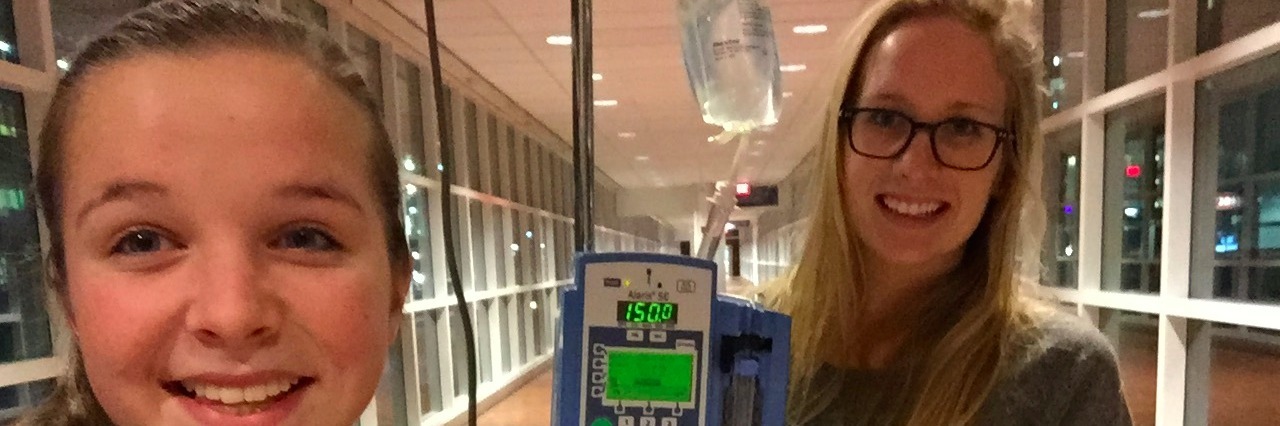 What Dysautonomia and POTS Symptoms Feel Like girl standing next to iv poll with a friend