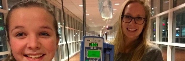 girl standing next to iv poll with a friend