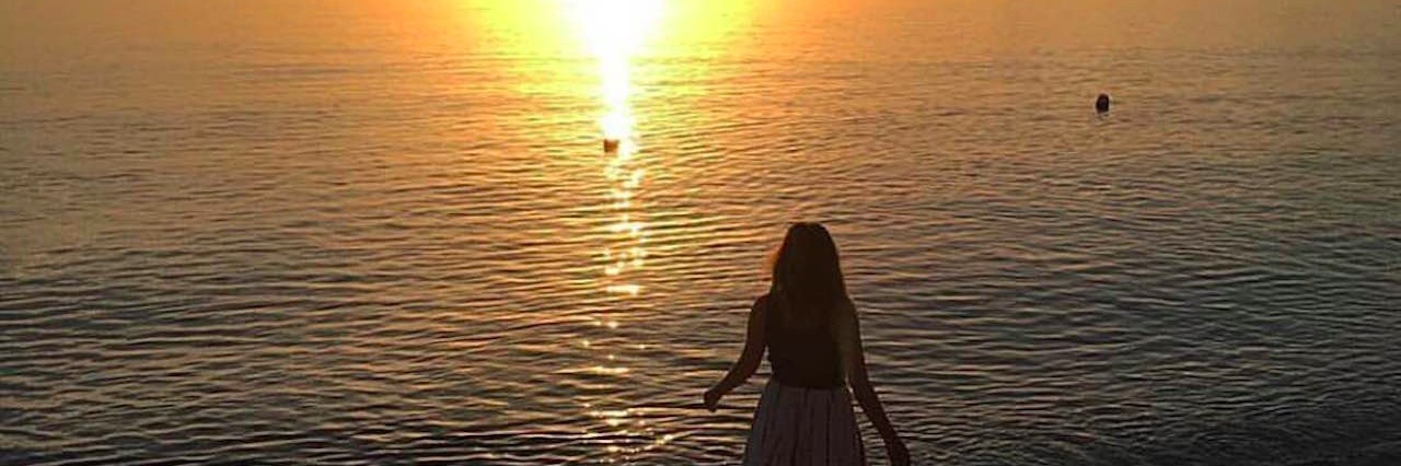 Dealing With Anxiety: What I've Learned woman standing on the beach at sunset