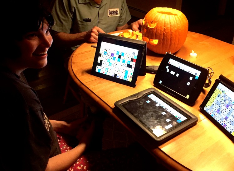 Jess with her AAC device at a table