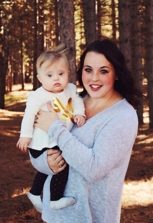 Woman holding baby in autumn park