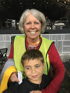 female security guard posing with young boy at concert