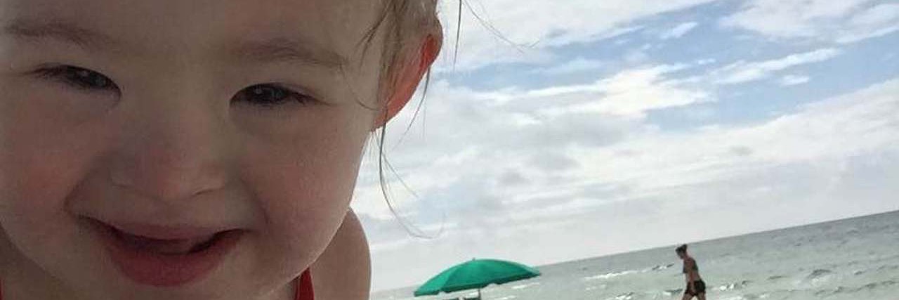 Mom's Response to the Person Making Fun of People With Disabilities Baby girl on the sand at the beach