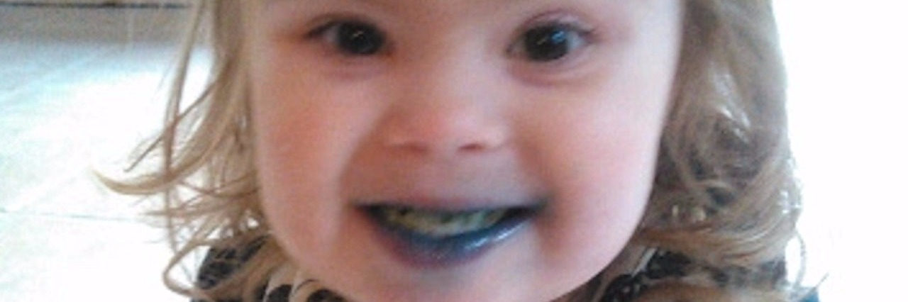 Dropping Gluten After My Child Was Diagnosed With Celiac Disease little girl after eating a green-colored sucker