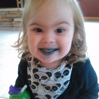 little girl after eating a green-colored sucker