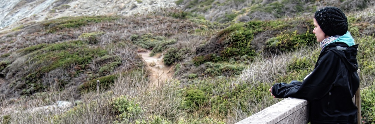 Not Feeling Deserving of Love as Someone With Ehlers-Danlos Syndrome woman standing on a bridge and looking at scenery