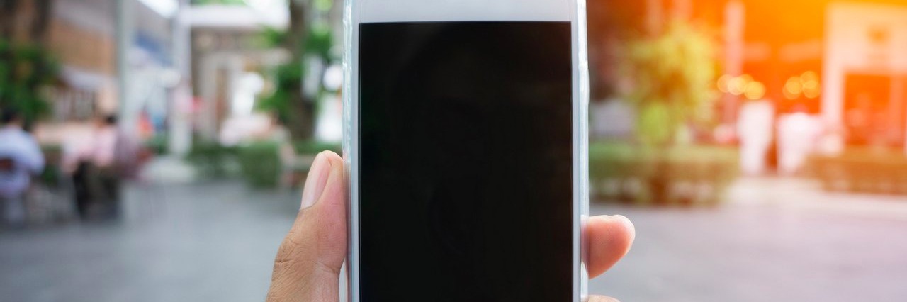 Woman Asks People to Stop Taking Her Photo Because of Her Dwarfism man holding smartphone