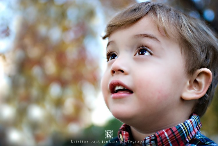 Young boy outside looking up