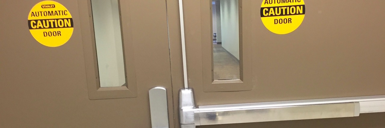 What It's Like to Visit a Loved One at a Psychiatric Hospital doors at the entry of a mental hospital unit