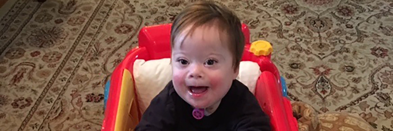 My Son With Down Syndrome's Life Is About More Than Milestones Miles in his toy car.