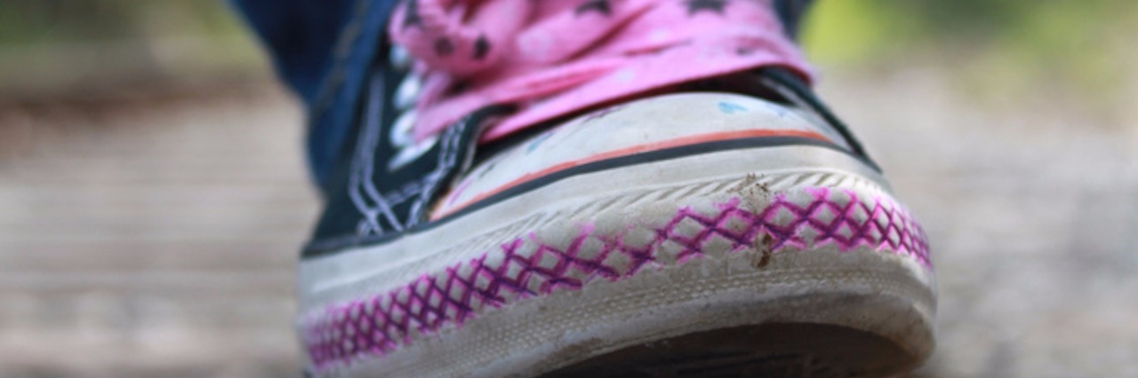 What to Know About Bipolar Depression pink shoe walking on a balance beam