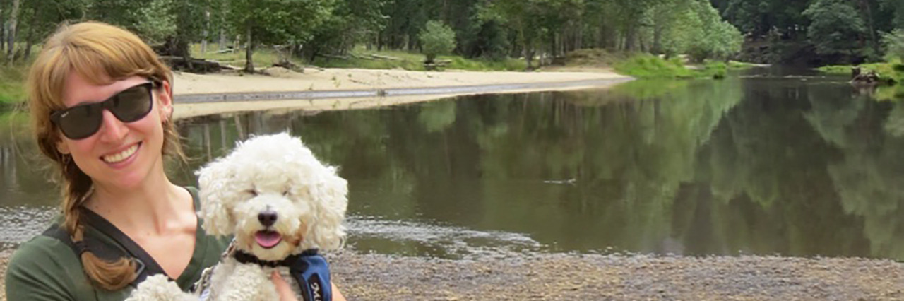 How My Identity Has Evolved Along My Journey With Low Vision Jen Pearlstein at Yosemite National Park with her cervice dog, a white poodle.