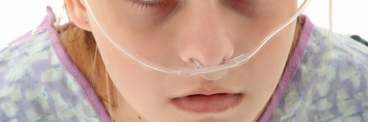 Pulmonary Hypertension and Halloween: Oxygen Tanks Are Not Costumes Ill american 16 year old girl in hospital gown with oxygen tube over white background.