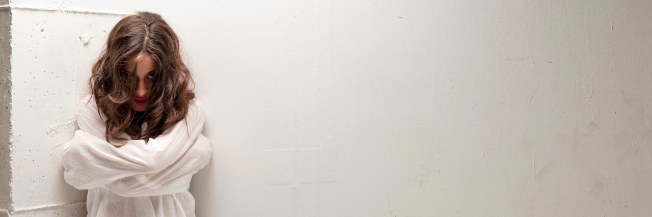 Why You Shouldn't Dress as a 'Mentally Ill Patient' Young woman with straitjacket