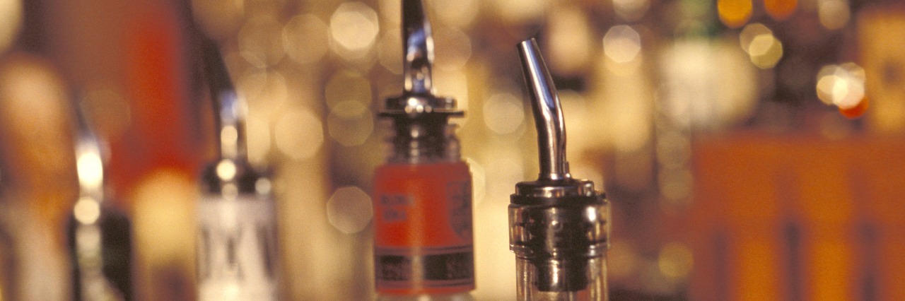 7 Life Lessons I Learned From Getting Sober at 20 Years Old bottles of liquor at a bar