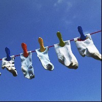 a row of socks hanging on a clothesline