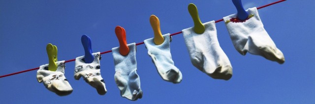 a row of socks hanging on a clothesline