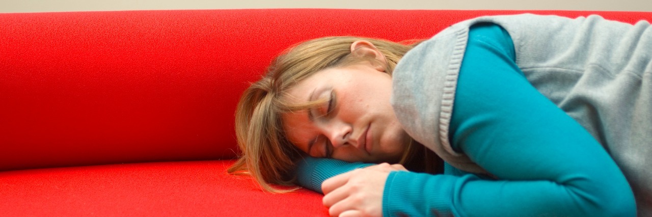 Things I Wish People Understood About Chronic Fatigue Syndrome woman sleeping on red couch