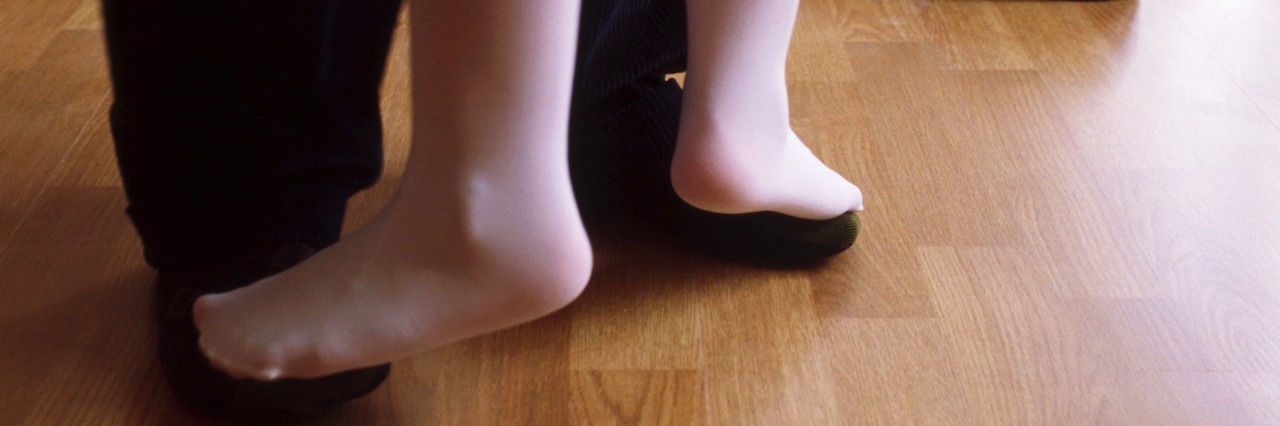 A Letter to My Daughters Explaining My Depression a little girl dancing with her feat on her father's feet