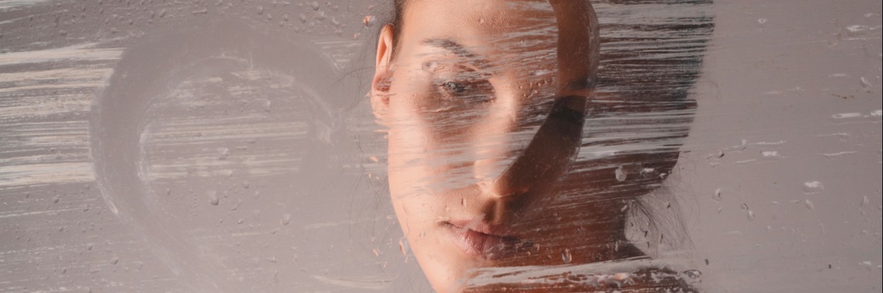 Almost Relapsing Into Self-Harm girl draws a heart on the glass