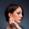 Profile of woman with hand near her ear