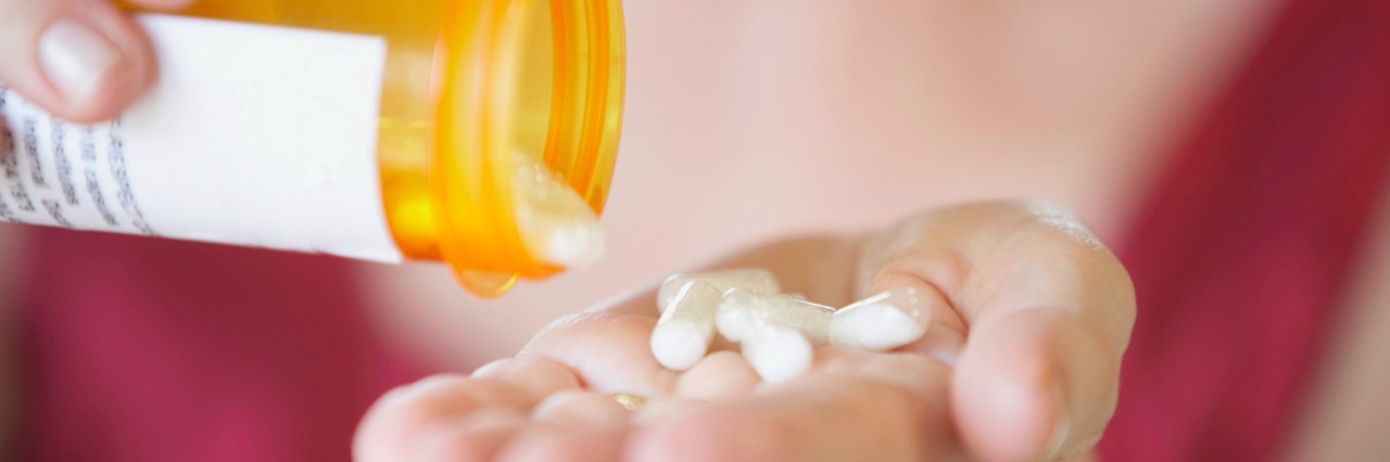 Why Starting a New Medicine Is Stressful Close-up of a person's hands holding a bottle of pills