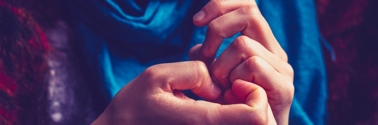 Realizing My 'Nail Picking' Is a Disorder Called Onychotillomania woman picking at her nails