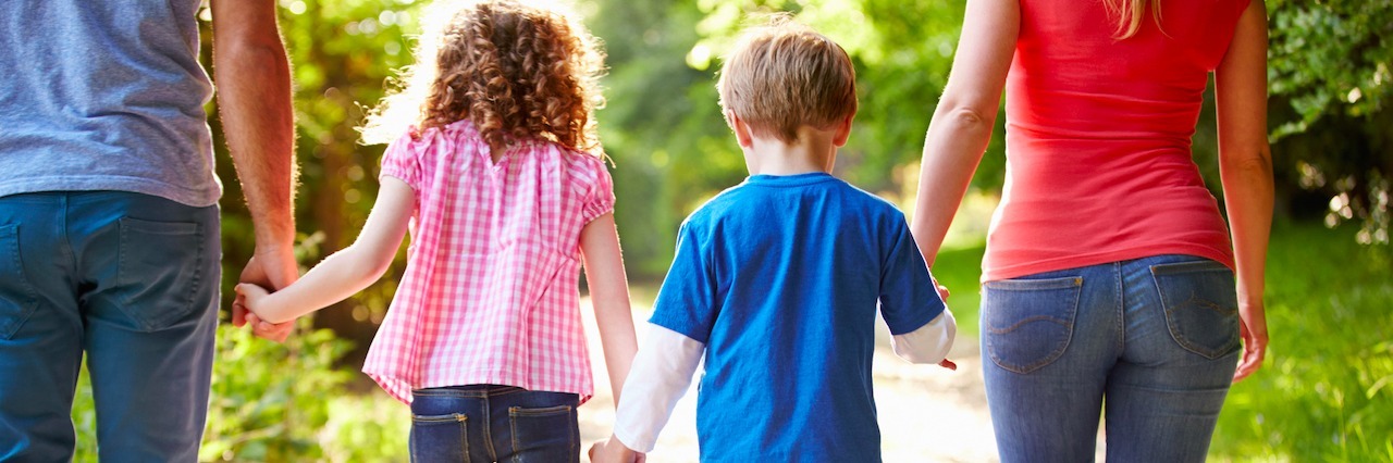 How Mental Illness Can Affect an Entire Family family holding hands walking down a path