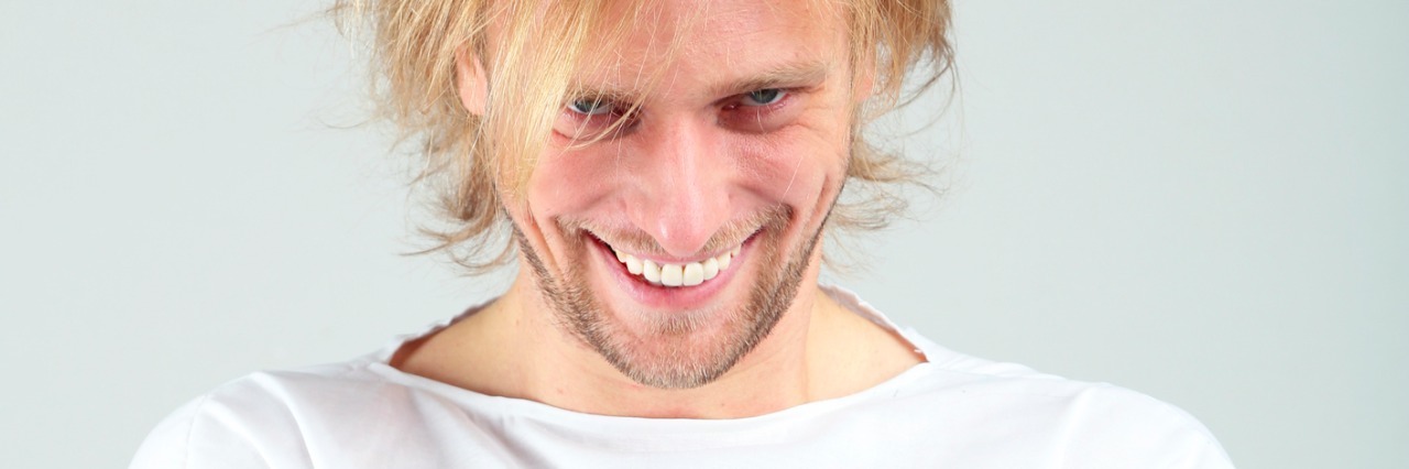 What to Do When You See Mental Illness as a Costume costume of Mentally ill man in strait-jacket on gray background