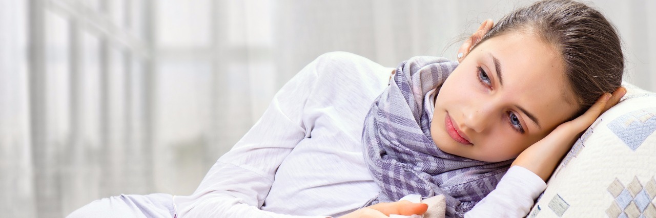 Why People Who Are Sick Say No to Invitations sick woman lying on couch