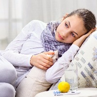 sick woman lying on couch